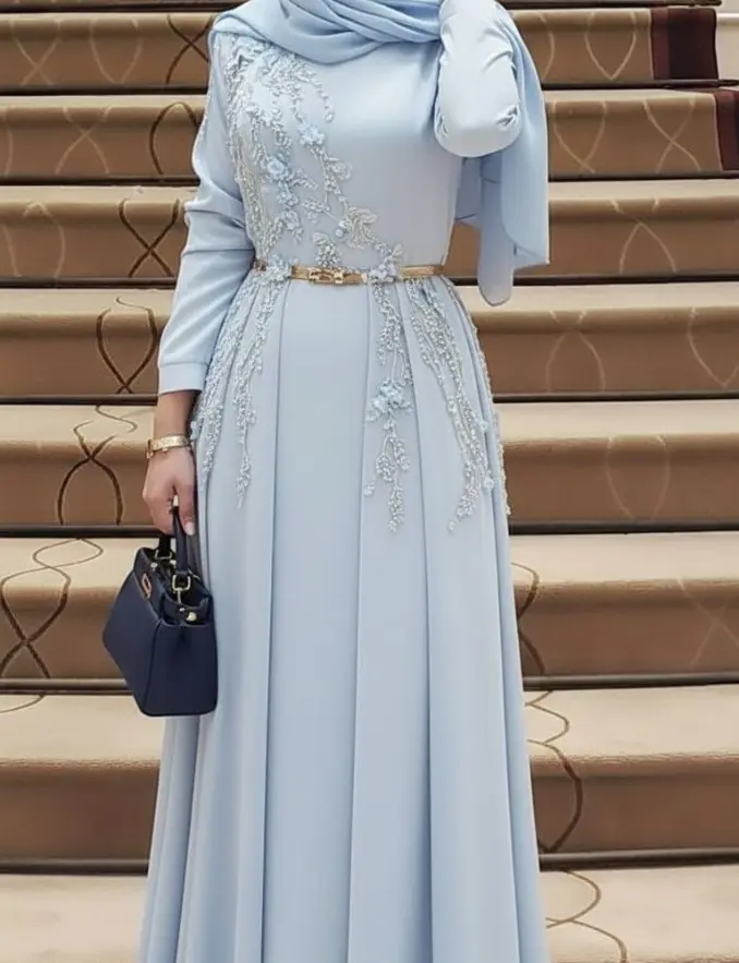 A woman wearing a sky blue belted abaya and hijab, showcasing elegance and style